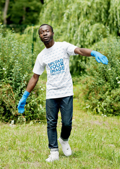 T-Shirt Mockup of a Serious Man Walking in the Grass With Gloves m7222 r-el2