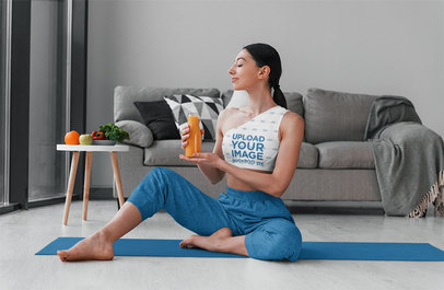 One-Shoulder Sports Bra Mockup Featuring a Woman Holding an Orange Juice