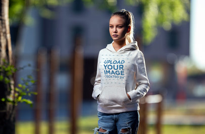 Pullover Hoodie Mockup Featuring a Serious Woman With a Ponytail Hairstyle