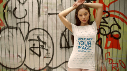 T-Shirt Video of a Woman Posing in Front of a Metal Door with Graffiti 3669v