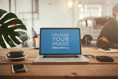 Mockup of a MacBook Placed On a Wooden Table in an Office m11785-r-el2