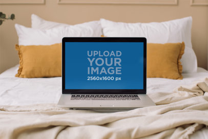 Mockup of a MacBook Pro Placed on a Bed