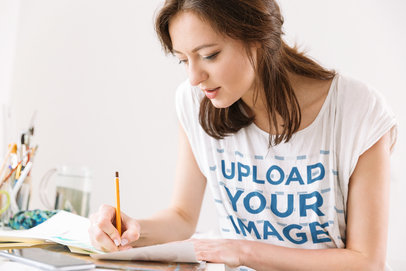 T-Shirt Mockup of a Woman Writing Down Notes 39956-r-el2