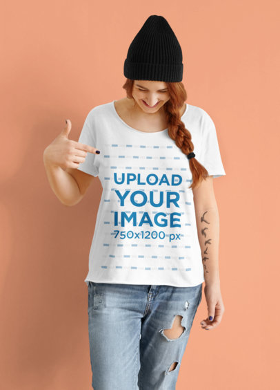 Mockup of a Tattooed Woman Pointing at Her T-Shirt in a Studio