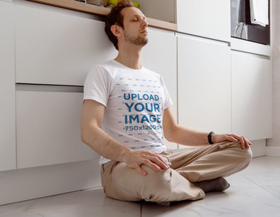 T-Shirt Mockup Featuring an Exhausted Man Sitting on the Floor at Home m11364 r-el2