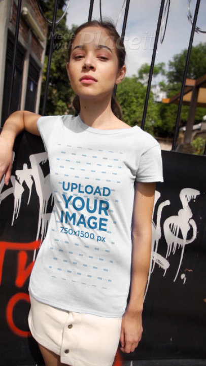 T-Shirt Video of a Young Woman in Front of a Wall With Graffiti 