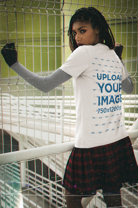 Back View T-Shirt Mockup Featuring a Serious Woman in a 90s Outfit 