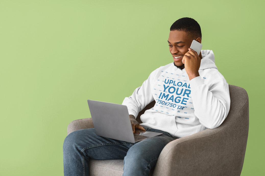 Hoodie Mockup of a Man Working at Home