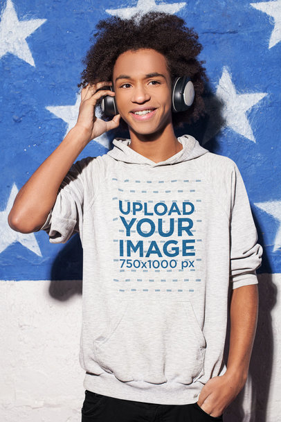 Hoodie Mockup Featuring a Happy Teenage Boy Using Headphones