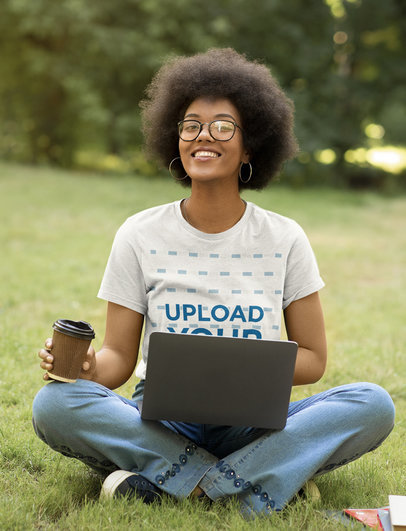 Round-Neck T-Shirt Mockup of a Happy Woman Working on Her Laptop at a Garden