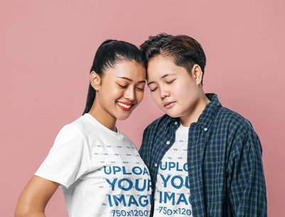 T-Shirt Mockup of a Happy Women Couple Posing Against a Customizable Background