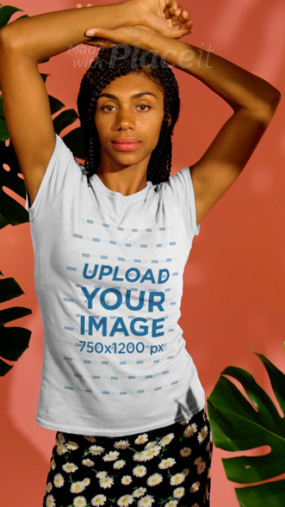 T-Shirt Video Featuring a Happy Young Woman Posing by Some Tropical Plants 