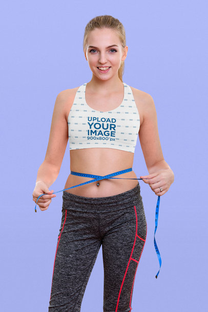 Sports Bra Mockup Featuring a Woman Measuring Her Waist