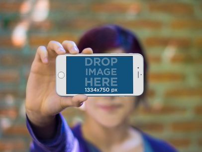 Mockup of a Blurry Woman Holding an iPhone 6
