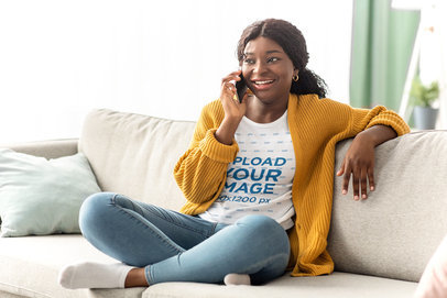 T-Shirt Mockup Featuring a Woman Talking on the Phone at Home