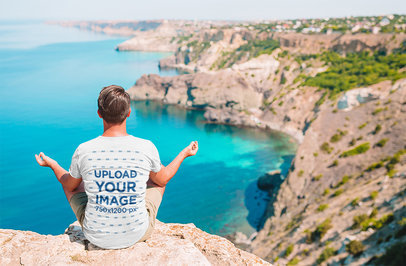 Back-View Heathered T-Shirt Mockup of a Man Practicing Yoga on a Mountain