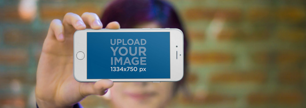 Wide Mockup of a Blurry Woman Holding an iPhone 6