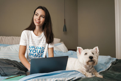 T-Shirt Mockup Featuring a Young Woman Doing Homework and Her Dog