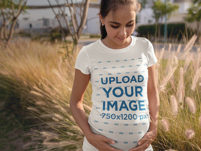 Facebook Ads - Pregnant Mom Looking to the Floor While Wearing a Tee Outdoors a16325