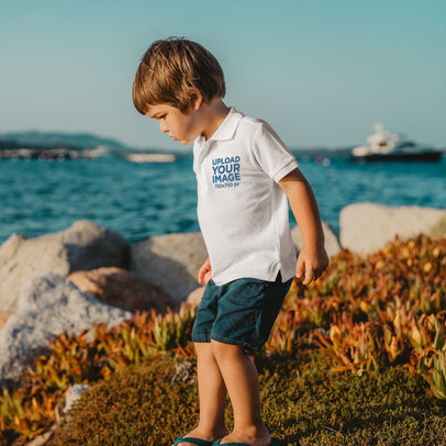Mockup of a Little Boy Wearing a Polo Shirt at the Beach