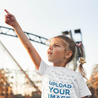 Round-Neck T-Shirt Mockup of a Girl Pointing at the Sky