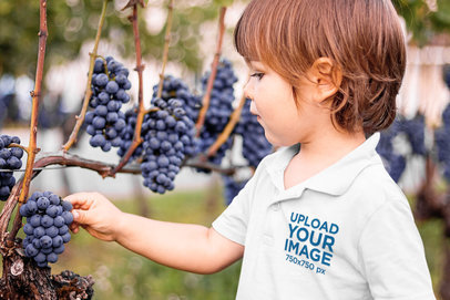 Polo Shirt Mockup of a Little Boy Picking Fresh Blueberries