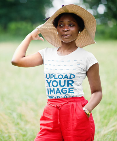 Round-Neck Tee Mockup of a Woman with a Hat in an Open Field
