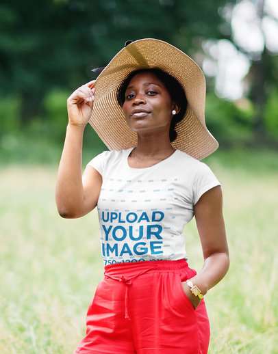 T-Shirt Mockup of a Proud Woman Posing on a Green Field