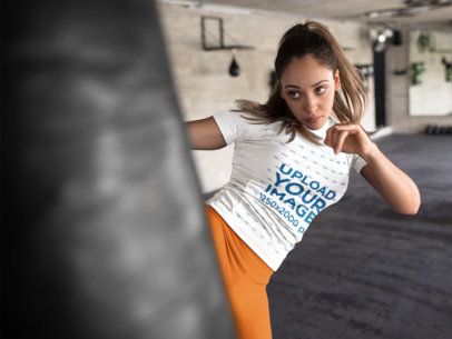Mockup of a Woman Kicking a Heavy Bag in a Boxfit Class Wearing Custom Sportswear