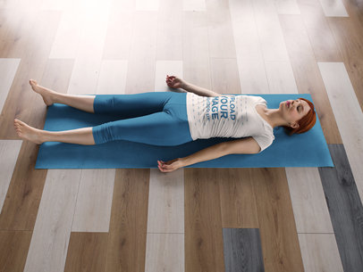 Mockup of a Woman Doing a Shavasana While Wearing Custom Sportswear