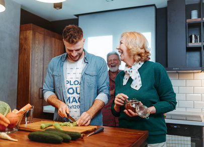 T-Shirt Mockup Featuring a Happy Man Cooking With His Parents