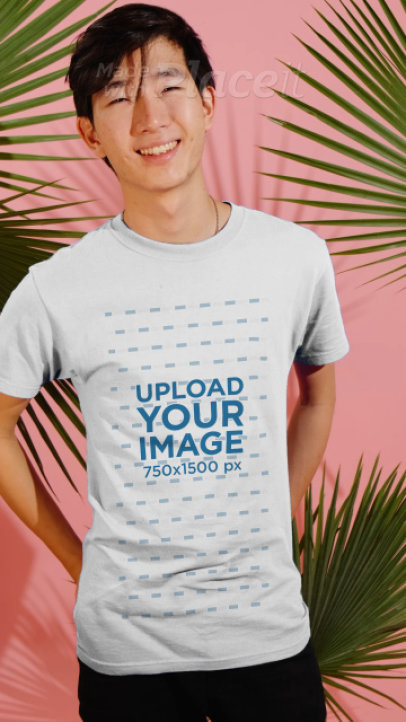 T-Shirt Video Featuring a Happy Young Man Surrounded by Palm Leaves 