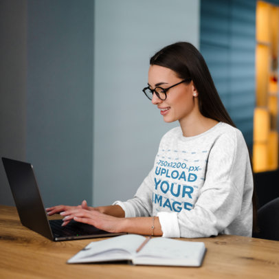 Heathered Sweatshirt Mockup Featuring a Woman With Glasses Working M12576-r-el2