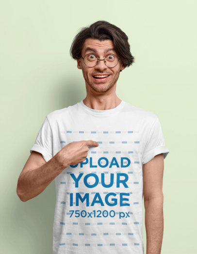 T-Shirt Mockup Featuring a Surprised Man In a Studio