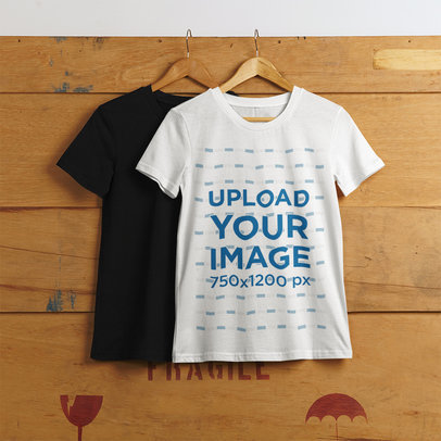Mockup of Two T-Shirts with Round Necks Hanging on a Wooden Box
