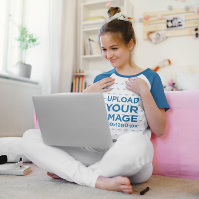 Mockup of a Young Woman Wearing a Raglan Tee While Having a Video Conference