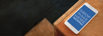 Wide Mockup of an iPhone 6 on Top of a Wooden Desk