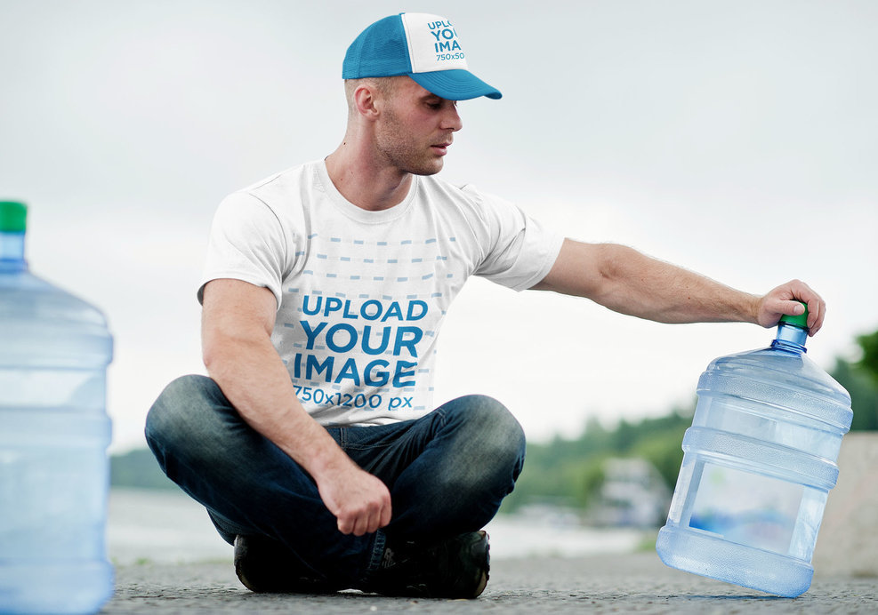 T-Shirt and Truck Hat Mockup Featuring a Delivery Man Sitting and Holding a Bottle of Water