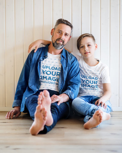 T-Shirt Mockup Featuring a Father and His Son Sitting at Home