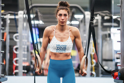 Sublimated Sports Bra Mockup of a Woman Using Gymnastic Rings