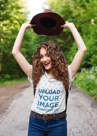 Heathered T-Shirt Mockup Featuring a Cheerful Woman With a Hat