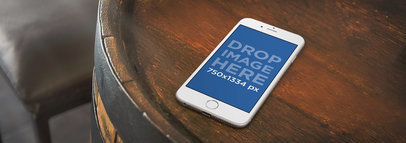 Wide Mockup of an iPhone 6 on Top of Barrel 