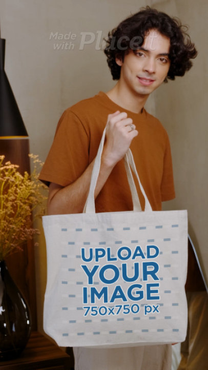 Video of a Young Man Holding a Customizable Tote Bag 