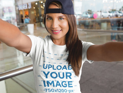 Selfie of a Woman Wearing a Hat and a T-Shirt Mockup While at the Mall
