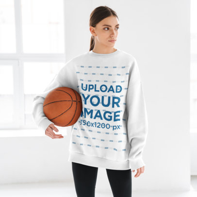 Sweatshirt Mockup Featuring a Woman Holding a Basketball