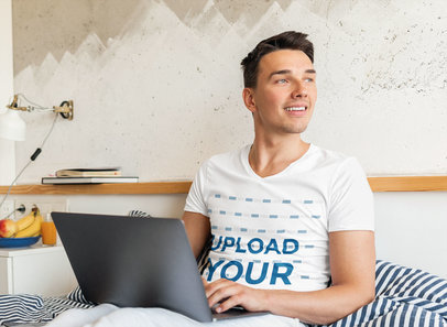 V-Neck Tee Mockup of a Young Man Working in Bed