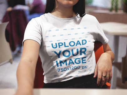 Mockup of a Cropped Face Woman Wearing a T-Shirt Indoors