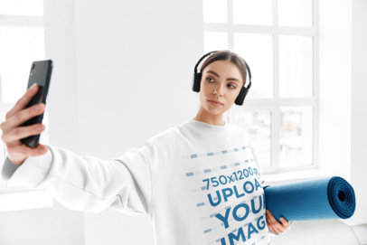 Mockup of a Woman with an Oversized Sweatshirt Taking a Selfie m10973 r-el2