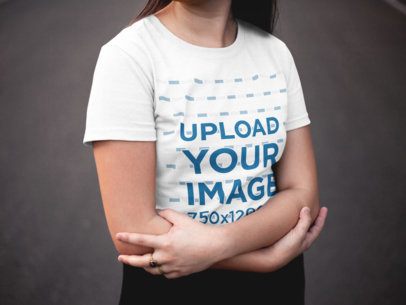 Studio Portrait of a Woman Wearing a T-Shirt Mockup While Crossing her Arms