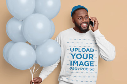 Sweatshirt Mockup of a Man Holding Colored Balloons While Talking on the Phone